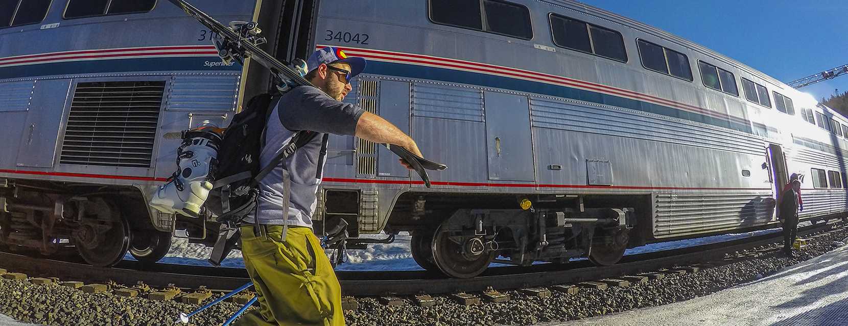 Skier walking from Winter Park Express Ski Train